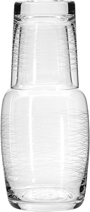 Clear glass carafe with small drinking glass as topper.