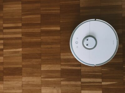 Robot vacuum operates on a hardwood floor.